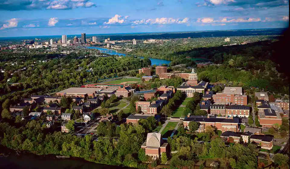 Drone shot of University of Rochester campus with city of Rochester in background.