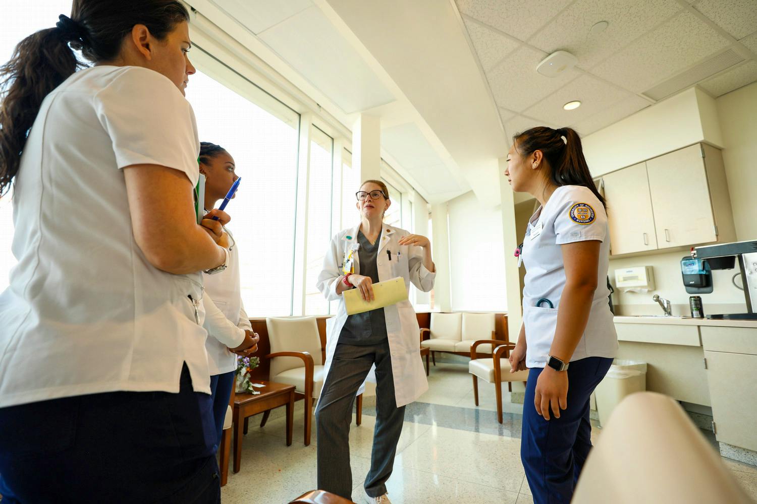 Accelerated nursing students talking with a nursing leader during an Admissions event