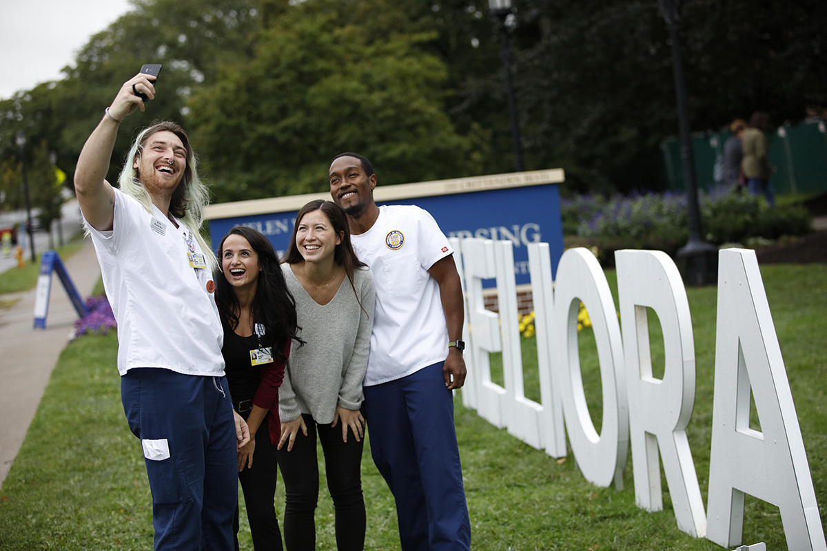 UR School of Nursing Students in Front of a Large Meliora Sign