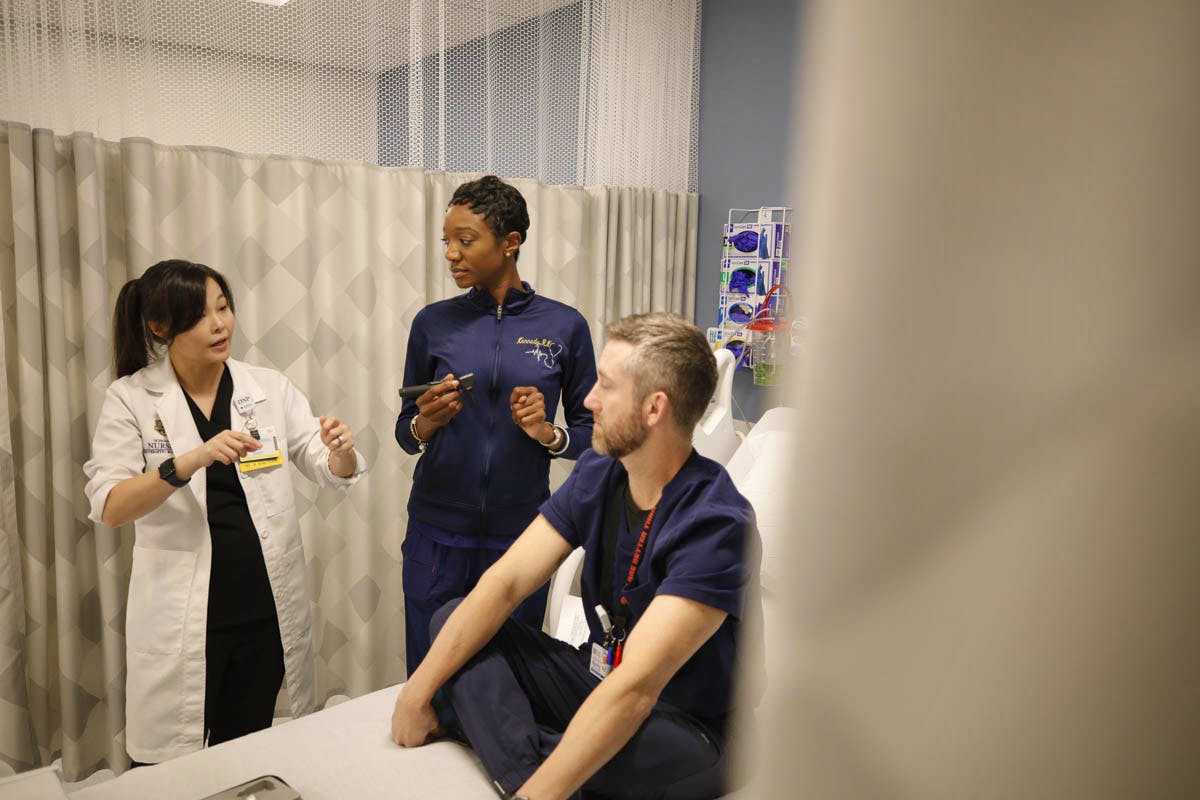 Students and faculty instructor in skills lab