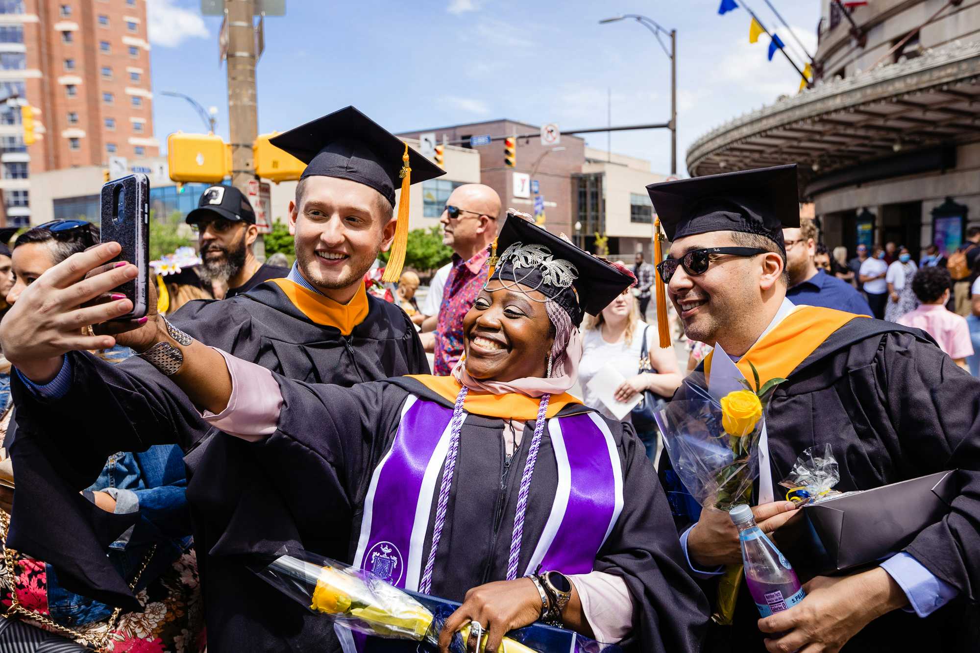 Students taking a selfie at Graduation Ceremony in Kodak Hall, Eastman Theatre