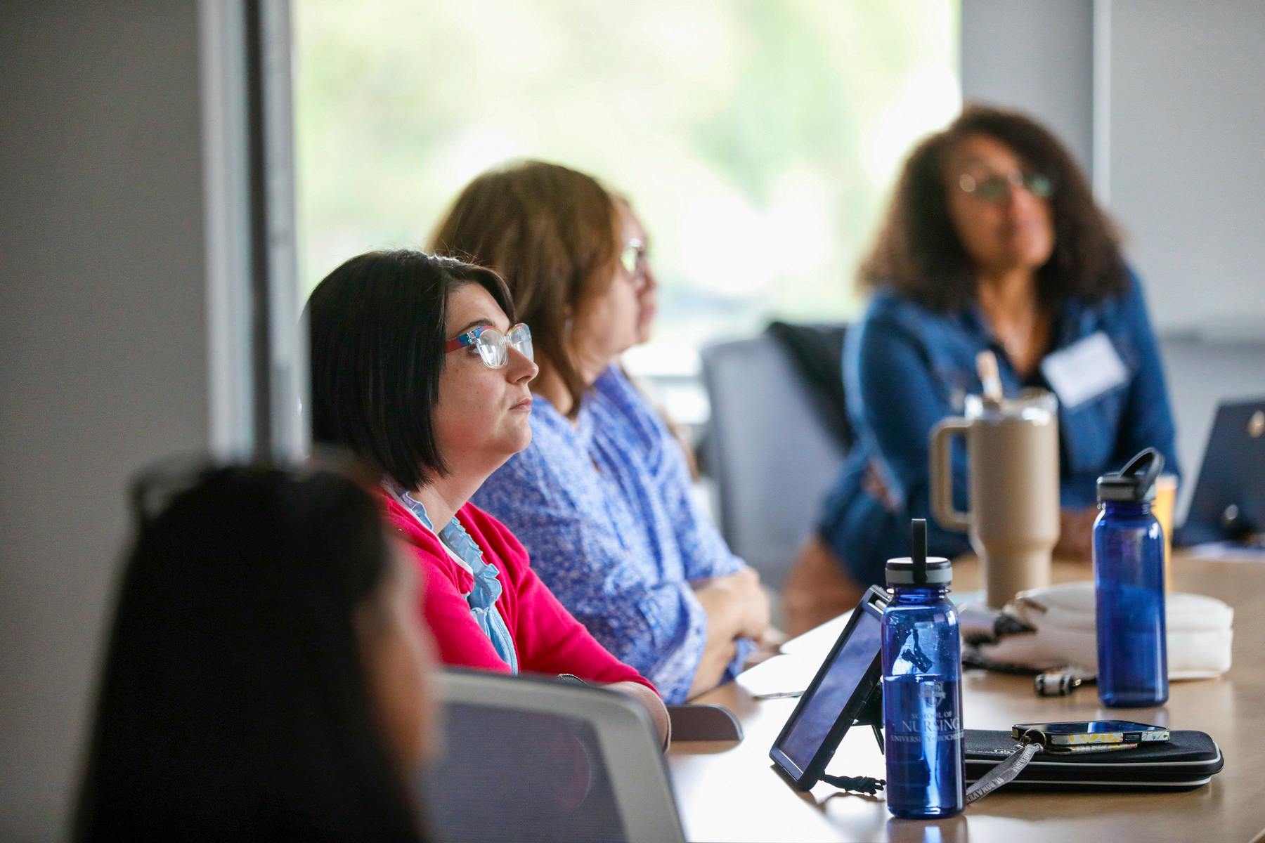 Summit attendees listening to a presentation