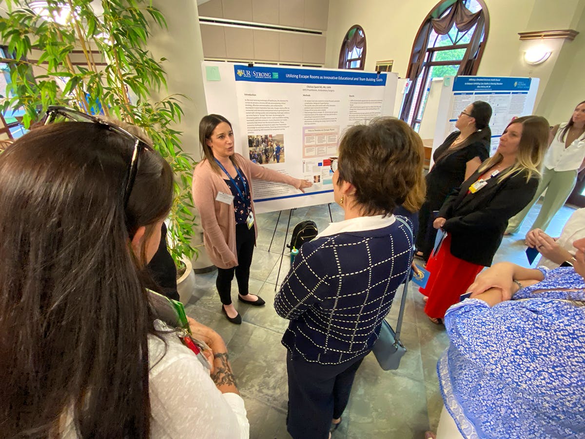 Close-up of a student's hand reaching towards an iPad screen