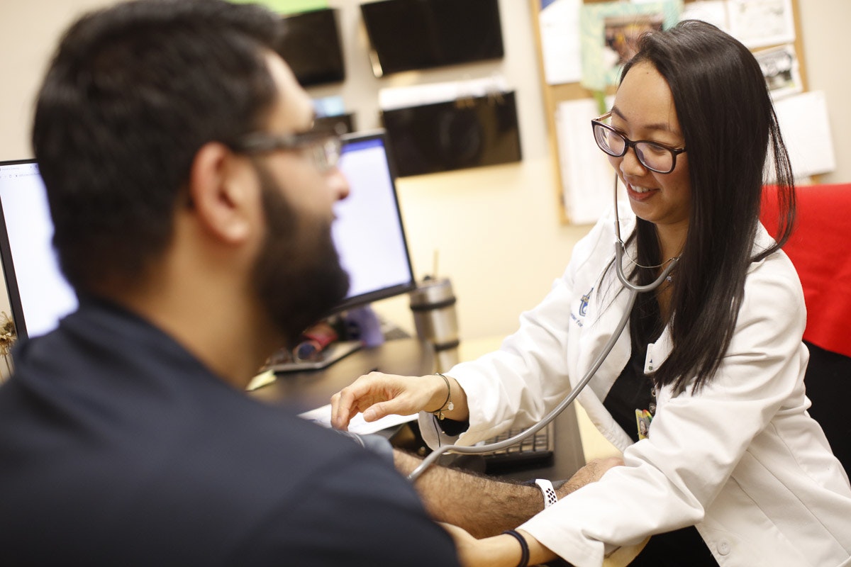 Nurse taking a patient's vital signs