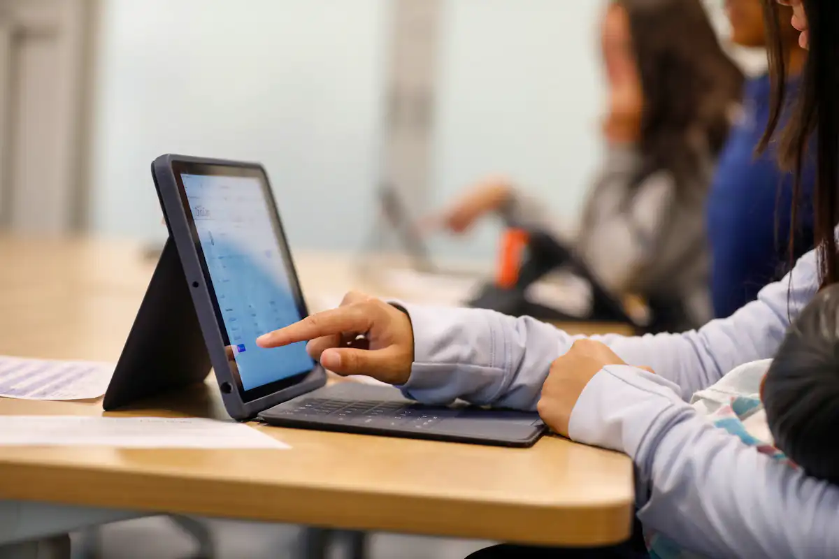Closeup image of student working on iPad device