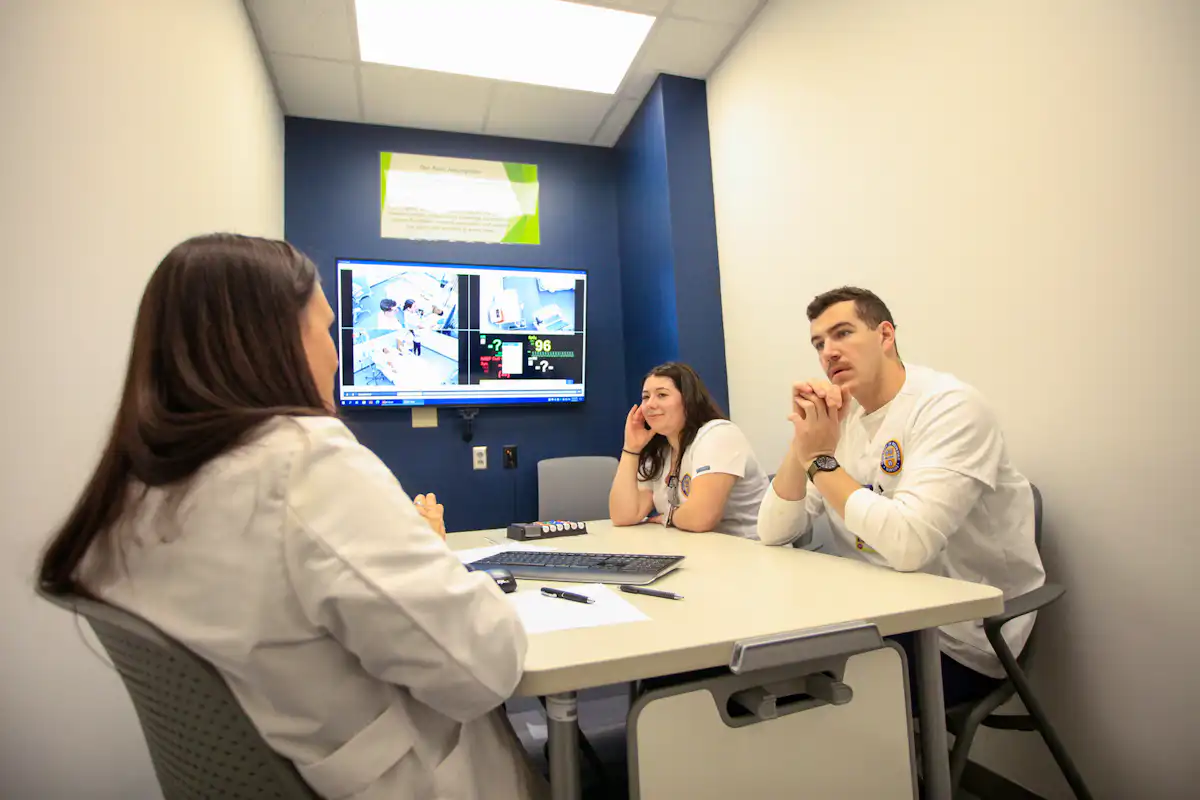 Students debriefing a simulation experience with their faculty instructor