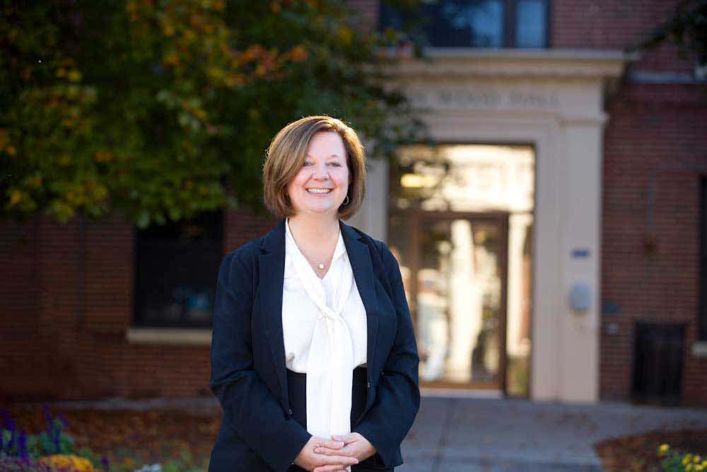 Dean Lisa Kitko in front of Helen Wood Hall