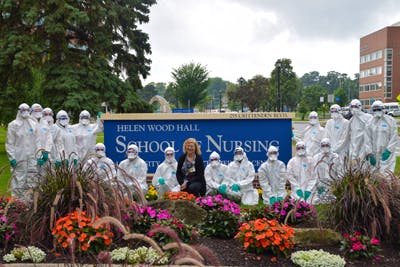 High school students participating in the pre-college program in nursing at the University of Rochester pose in their surgical gowns with Assistant Professor of Clinical Nursing Kathy Hiltunen.