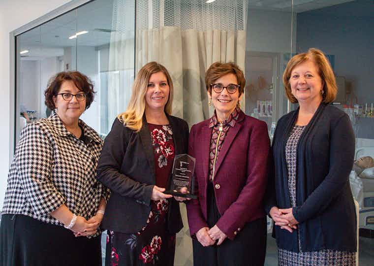 Lisa Brophy, Tara Serwetnyk, Lydia Rotondo, and Lisa Kitko accept the AACN Innovation Award.
