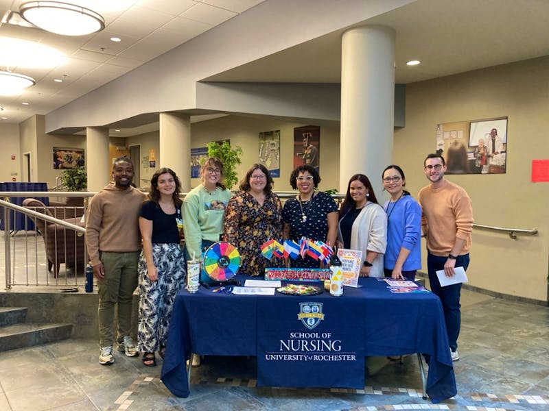 Group photo of the CoDEI and Student Affairs teams at a Hispanic Heritage Month table.