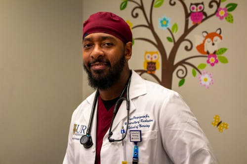 Jose Perpignan stands in a patient room at Rochester Asthma & Allergy.