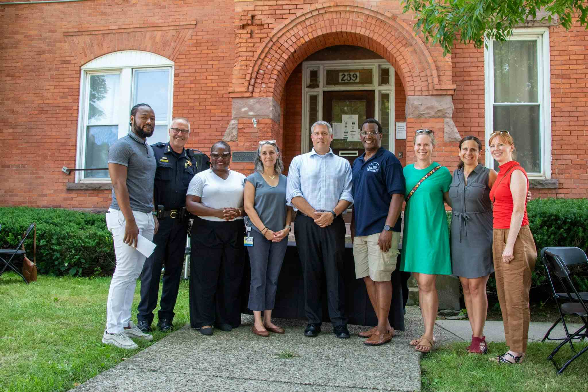 Recovery Houses, UR Nursing and CCHP team members gather outside a historic red brick house on Alphonse St. in Rochester.