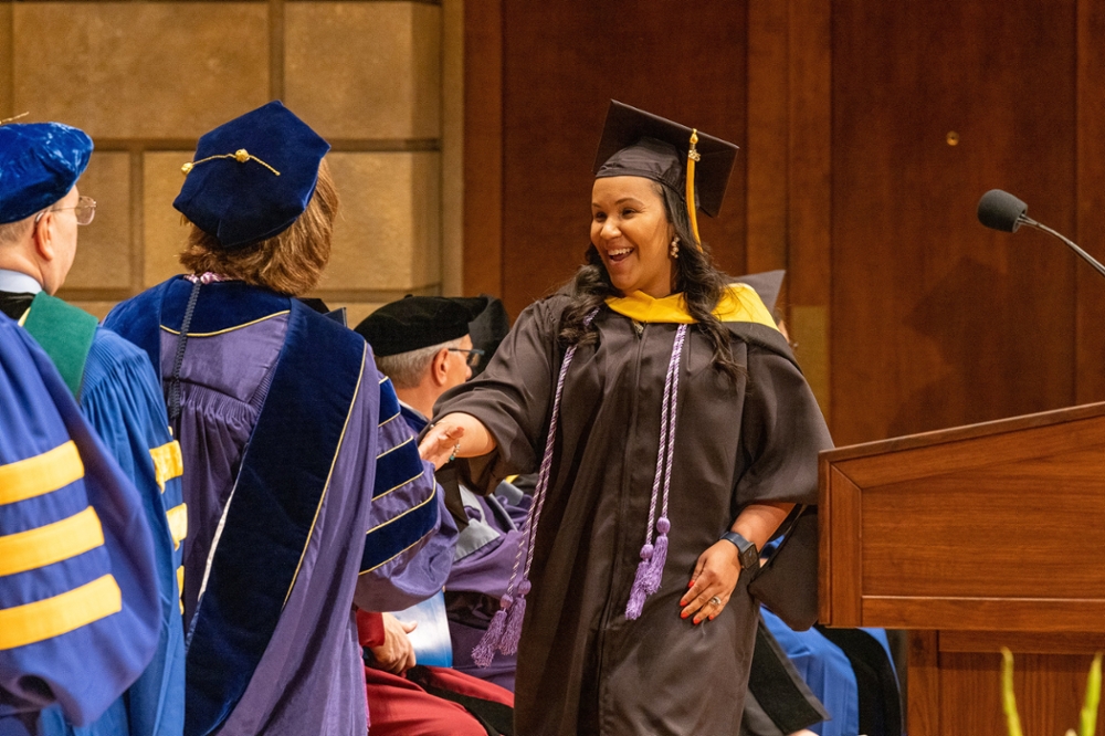 Evelyn Santos receives her diploma at the May 2023 graduation ceremony.