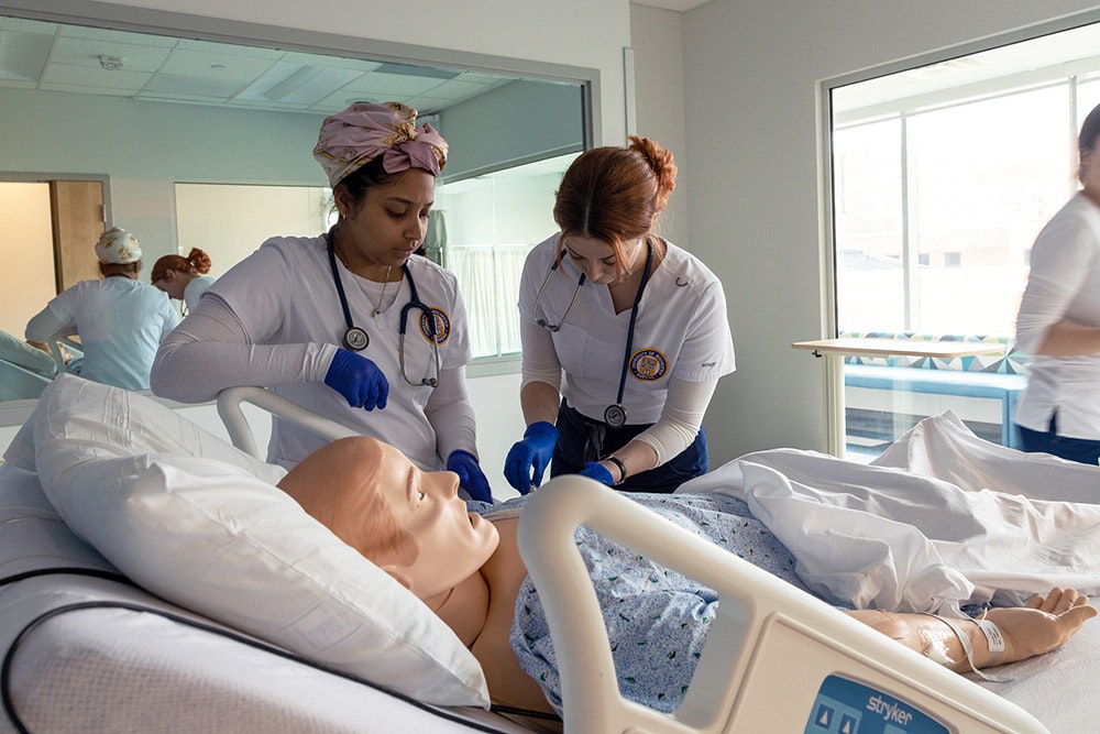Two ABSN students in simulation. 