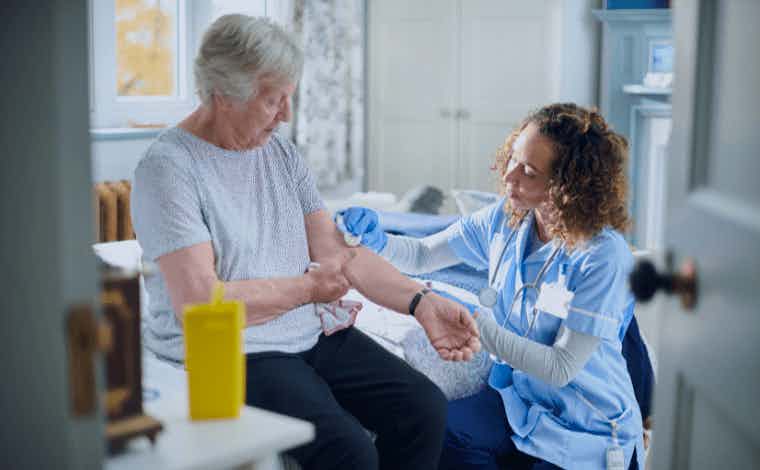 Older adult getting care from a health care worker