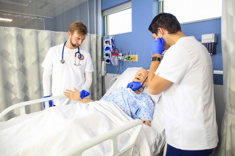 Accelerated Nursing Students working with a manikin.