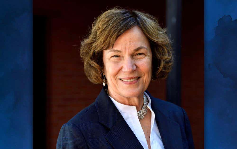 Headshot of Jacquelyn Campbell over a blue watercolor background