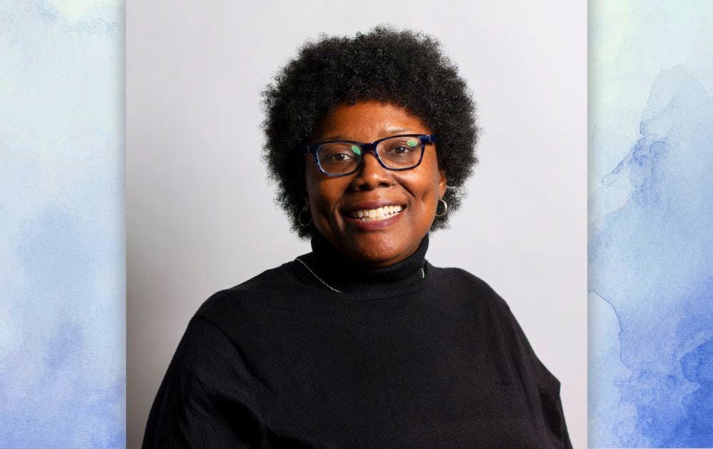Headshot of Tamala David over a white and blue watercolor background