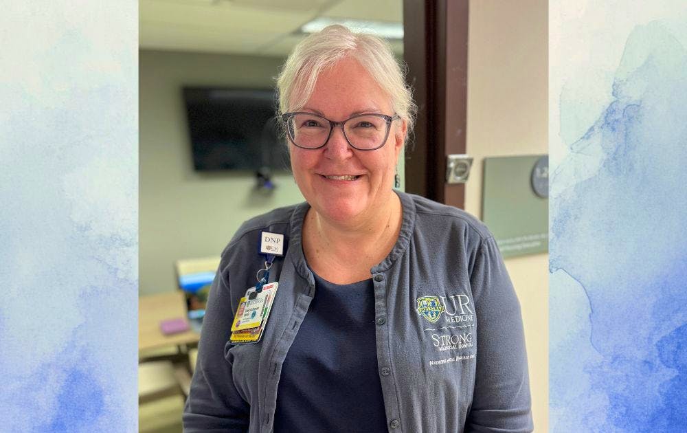 Headshot of Kate Valcin over a white and blue watercolor background