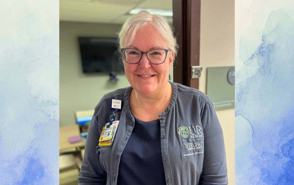 Headshot of Kate Valcin over a white and blue watercolor background