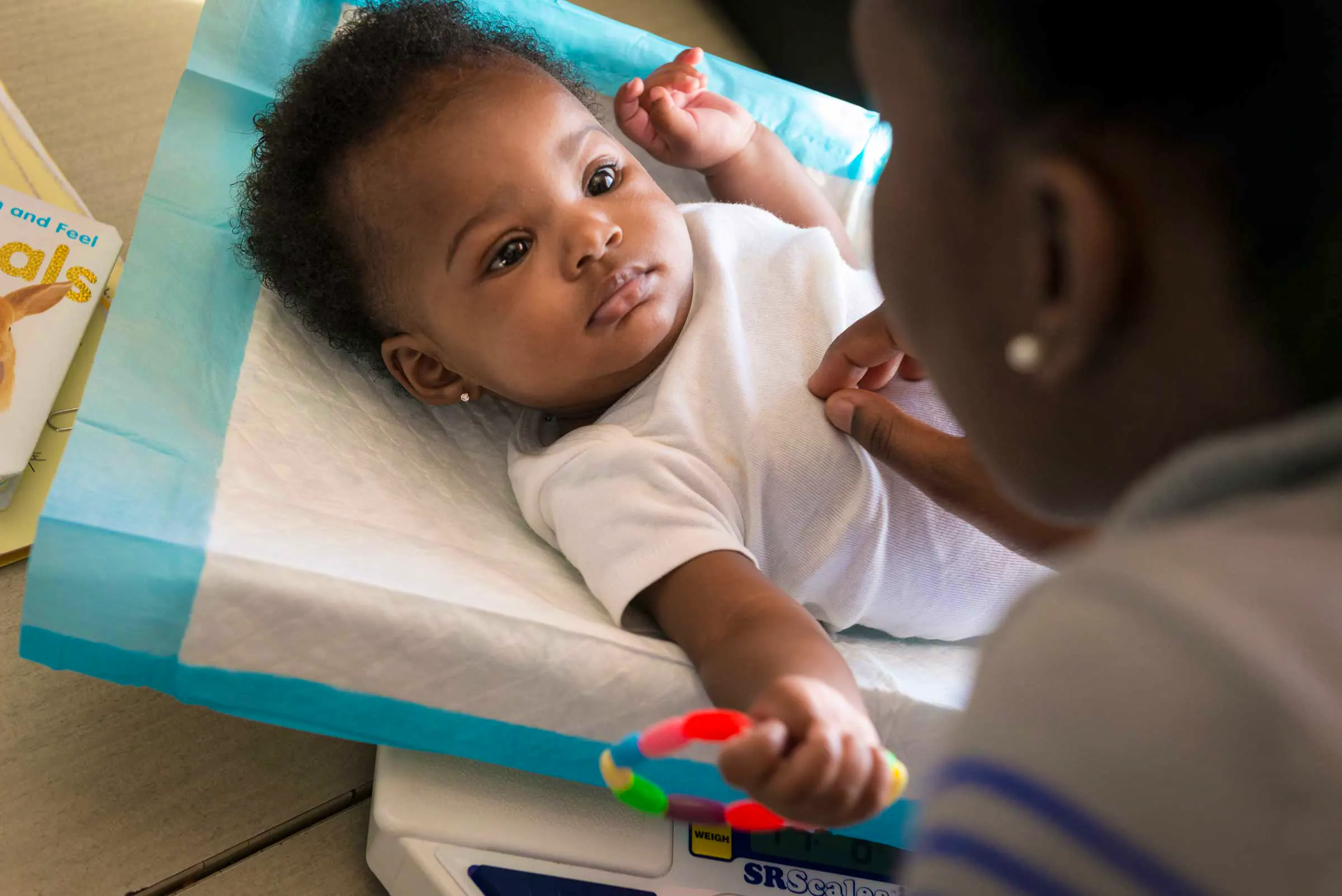 Woman interacting with infant in physician office environment