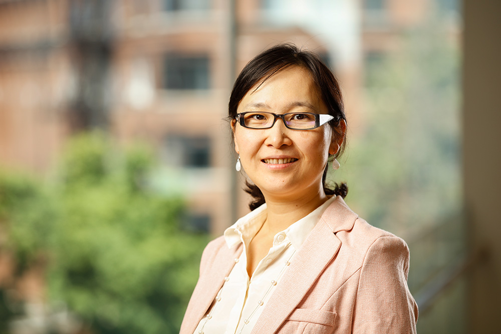 Headshot of Chen Zhang in the UR School of Nursing fourth floor lounge.