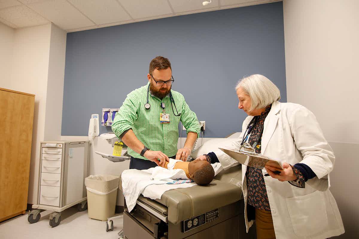 4 photos of students working with mannequins in the UR Nursing simulation suites and skills lab; INACSL Endorsement logo in the center of the photo.